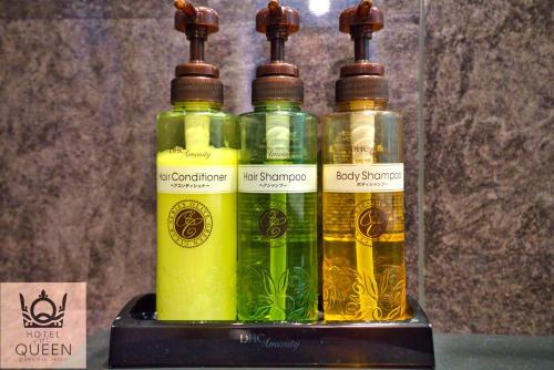 a group of four bottles of oil on a shelf at HOTEL the QUEEN in Toyonaka