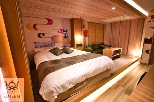 a bedroom with a bed and a living room at HOTEL the QUEEN in Toyonaka