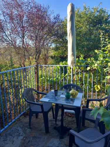 a table and chairs sitting on a patio at Gite Les Volets Bleus du Segur in Le Ségur-Suech