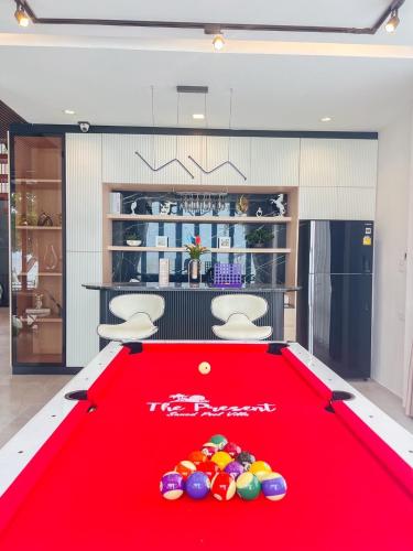 a red pool table with balls on top of it at The Present Samed pool villa in Ko Samed