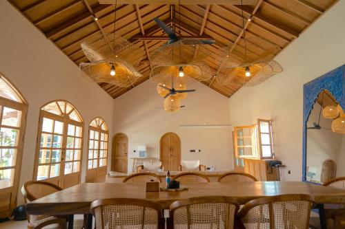 a dining room with a table and chairs at Casa Samudra - charming & spacious villa by the sea surrounded by nature in Selong Belanak
