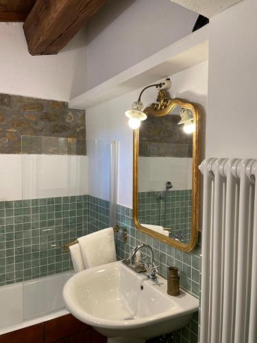 a bathroom with a sink and a mirror and a tub at Casina di Leonardo Arezzo in Arezzo