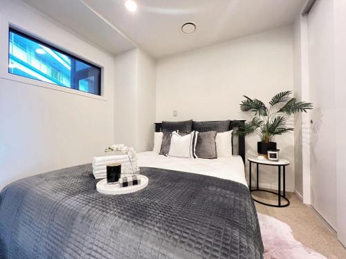 オークランドにあるStylish two-bedroom apartment in the city centerの大きなベッドと窓のある寝室
