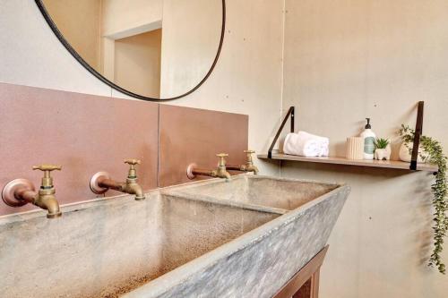 a bathroom with a sink and a mirror at Containers on Kidston in Mansfield