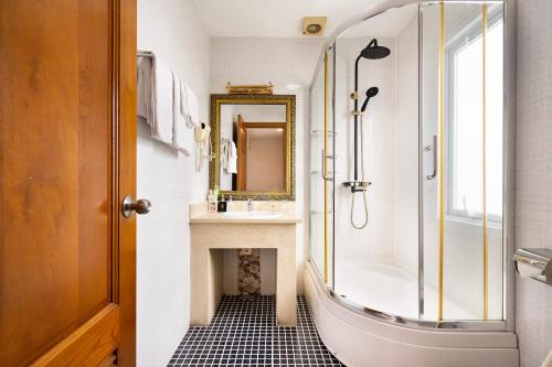 a bathroom with a shower and a sink and a mirror at Lam Kinh Hotel in Ho Chi Minh City