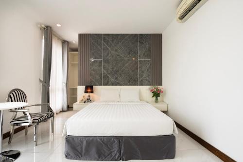 a bedroom with a bed and a table and chairs at Lam Kinh Hotel in Ho Chi Minh City