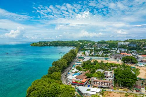an aerial view of a town next to the ocean at Phuket Meet Holiday Hotel-Rawai 普吉岛相遇花园度假酒店-拉威店 in Rawai Beach