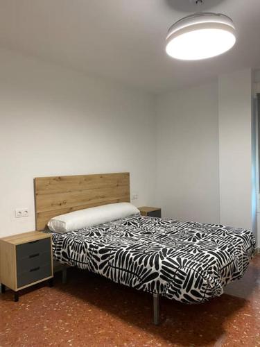 a bedroom with a zebra print bed and a lamp at Apartamento vacacional playa in Almería