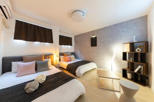 a hotel room with two beds in a room at Grandest living Nipponbashi 2Bedroom in Osaka
