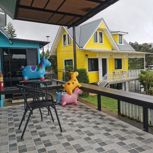 a house with some toy animals on a porch at โซพราว เขาค้อ So Proud Khaokho in Khao Kho