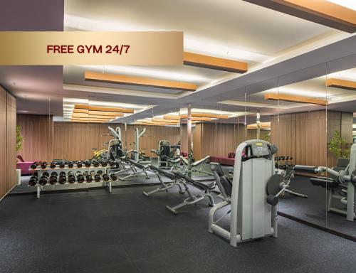 a gym with several treadmills and cardio machines at Signature by M Village Thợ Nhuộm in Hanoi