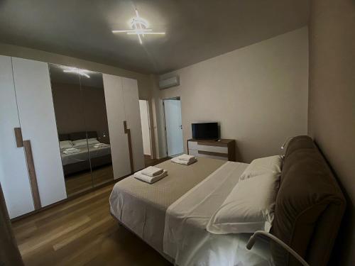 a bedroom with a bed and a large mirror at Casa Giorgia & Clara in Modugno