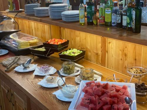 a buffet with fruits and vegetables on a table at Wellness Penzion Zora Family in Tatranská Lomnica