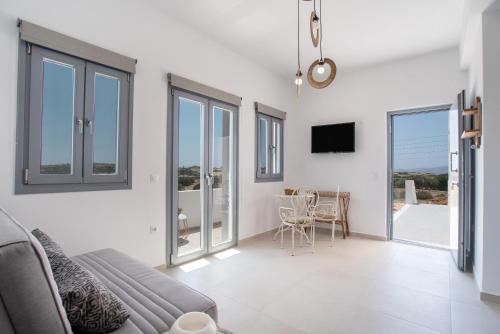 a living room with a couch and a table at Villa Anastasio in Kampos Paros