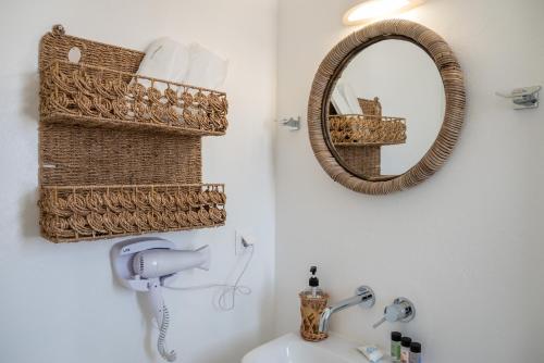 a bathroom with a mirror and a white sink at Villa Anastasio in Kampos Paros