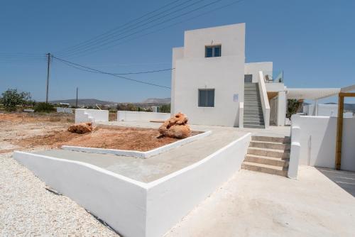 a white house with two teddy bears sitting on top of it at Villa Anastasio in Kampos Paros