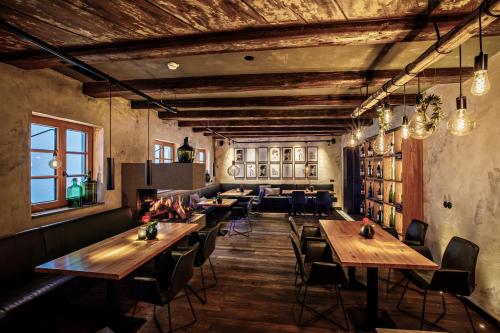 a restaurant with wooden tables and chairs in a room at Hotel Arthus in Aulendorf