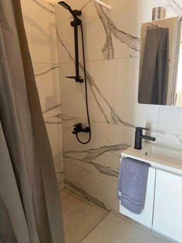 a bathroom with a shower and a sink at lacasadirigas in Lefkada