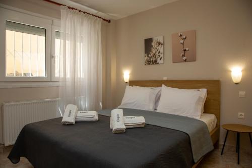 a bedroom with a bed with two towels on it at Utopia Inn in Néa Péramos