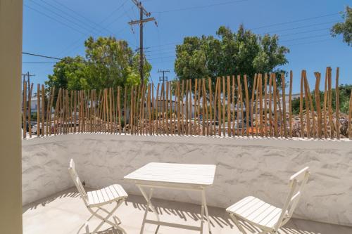 a table and two chairs next to a fence at Arco Solium Suites in Adamas
