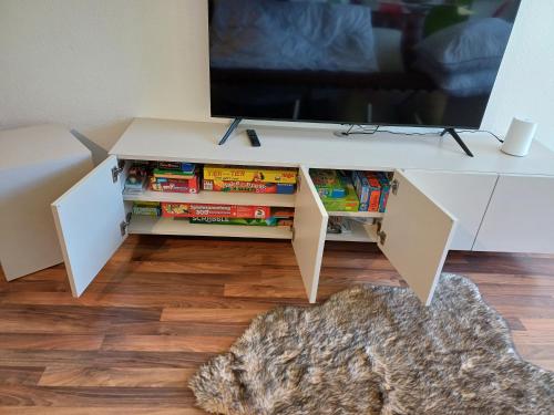 a white entertainment center with a tv on top at Ferienwohnung Panoramablick in Bad Wildbad