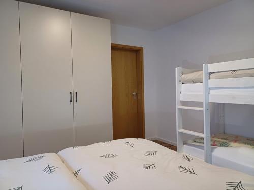 a bedroom with two bunk beds and a ladder at Ferienwohnung Panoramablick in Bad Wildbad