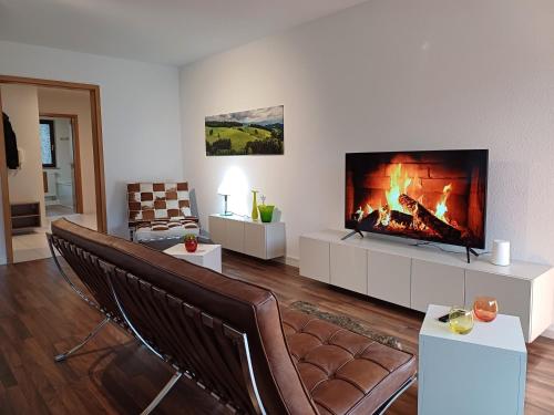 a living room with a fireplace and a couch at Ferienwohnung Panoramablick in Bad Wildbad