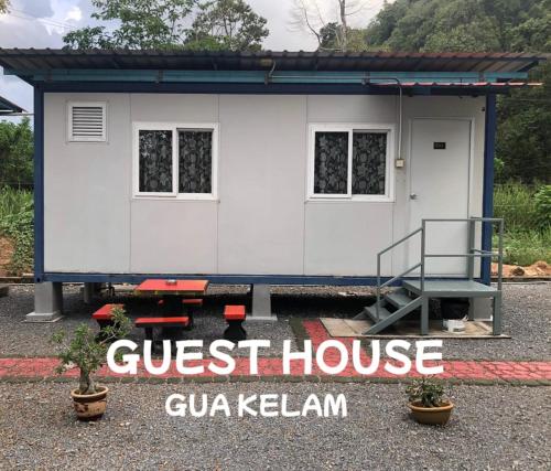 a tiny house on a trailer with a guest house at Guest House Gua Kelam in Kaki Bukit