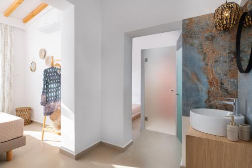 a bathroom with a sink and a bath tub at Amora Pool Villas in Gennadi