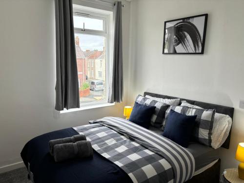 a bedroom with a bed with a window and a window at Blyth Royal, Free Parking in Bebside