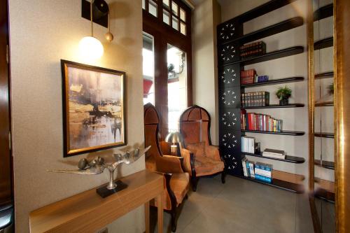 a room with two chairs and a table and bookshelves at Hotel Momento Golden Horn in Istanbul