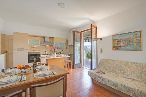 a living room with a couch and a table at Casa Virginia Apartments in Laveno-Mombello