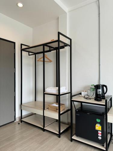 a black book shelf in a room at Luka House in Lam Luk Ka