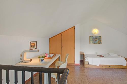 a living room with a table and a bed at Casa Virginia Apartments in Laveno-Mombello