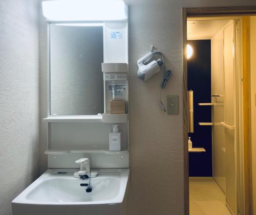 a bathroom with a sink and a mirror at Kyomachiya Daitokuji in Kyoto