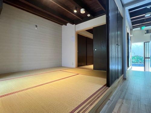 an empty room with a hallway with a door and a floor at Kyomachiya Daitokuji in Kyoto