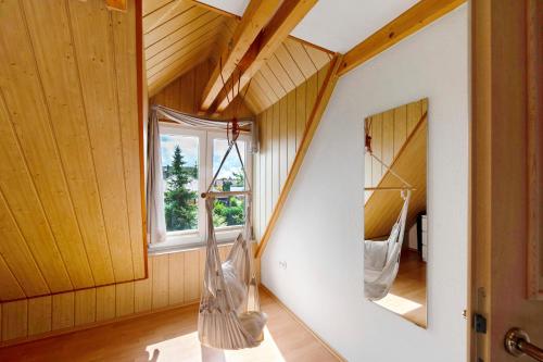 a room with wooden walls and a staircase with mirrors at Wellness Ferienwohnung Müller in Rostock