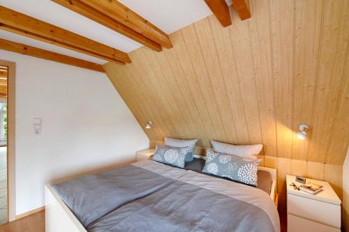 a bedroom with a bed with a wooden ceiling at Wellness Ferienwohnung Müller in Rostock