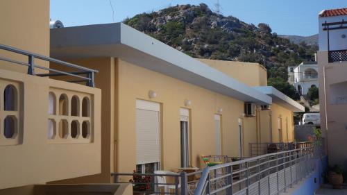 a balcony of a building with a mountain in the background at 4S Beach Superior Apartments in Stalida