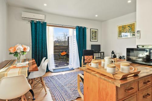 a living room with a table and chairs and a window at The Orange Cottage in Hamilton