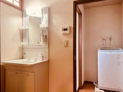a bathroom with a sink and a mirror at Kyomachiya Kitayamaomiya in Kyoto