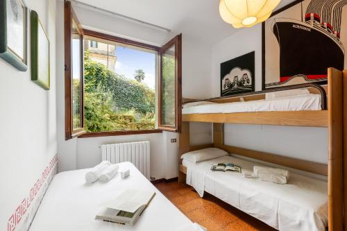 a room with two bunk beds and a window at Casa Virginia Apartments in Laveno-Mombello
