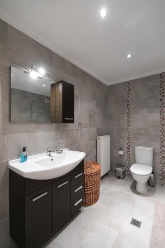 a bathroom with a sink and a toilet at Hemera House Posidi K3 in Possidi
