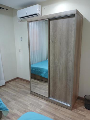 a room with a sliding glass door with a bed inside at Luxerious apartment with a private garden and pool access in Sheikh Zayed
