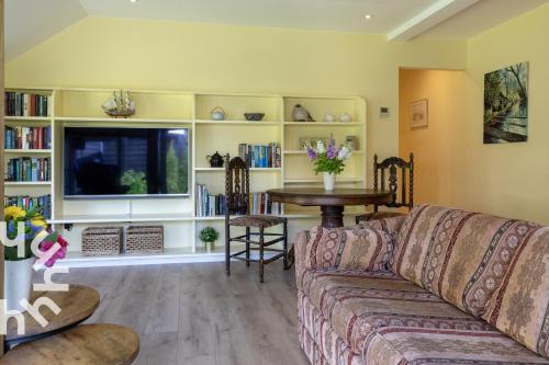 a living room with a couch and a table at OV592- 2P apartment in the heart of Giethoorn in Giethoorn