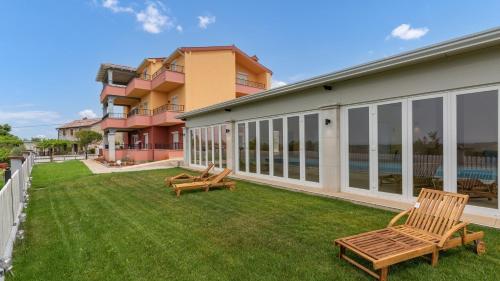 a yard with two benches and a building at Villa Damian in Umag