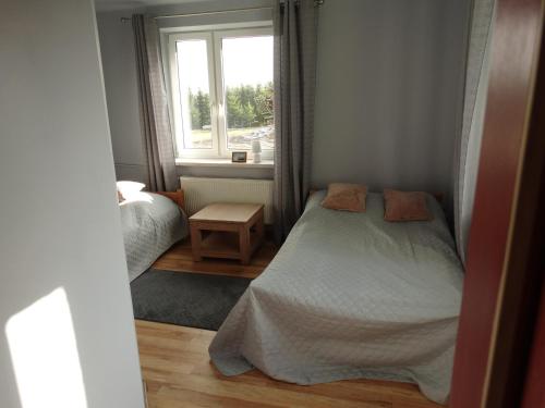 a small bedroom with a bed and a window at AgroGabi - Wypoczynek na Podlasiu in Burniszki