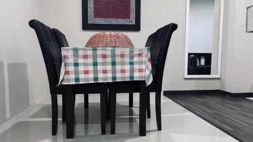 two chairs with a table with a pillow on it at Ada Hotel & Apartment in Kuala Terengganu