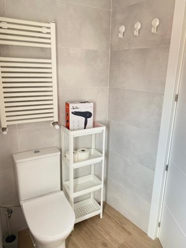 a bathroom with a white toilet in a room at Mundaka plaza in Mundaka