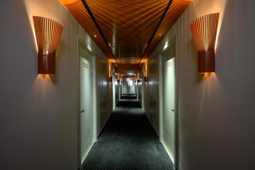 a hallway with two lights on the walls and a corridorngthngthngthngthngth at Prima Vera in Jerusalem